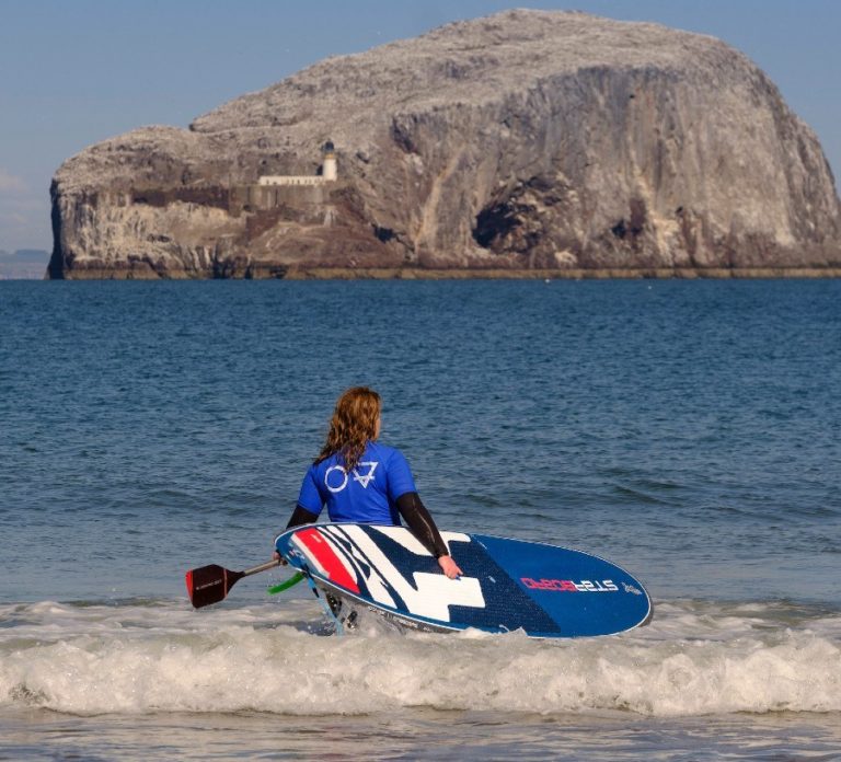 SUP paddle boarding with Starboard on Seacliff Beach in East Lothian with the Bass Rock in the background