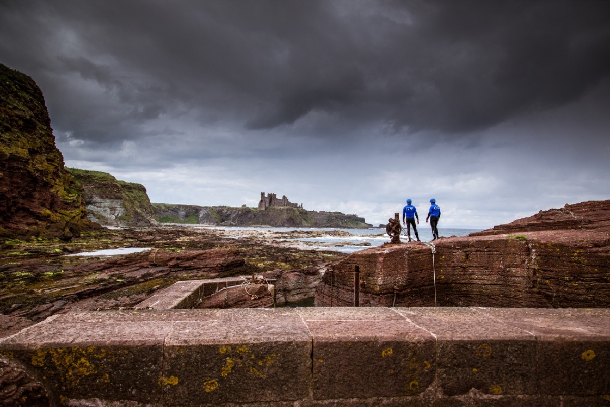 Coasteering In East Lothian by the harbour at Seacliff beach close to North Berwick