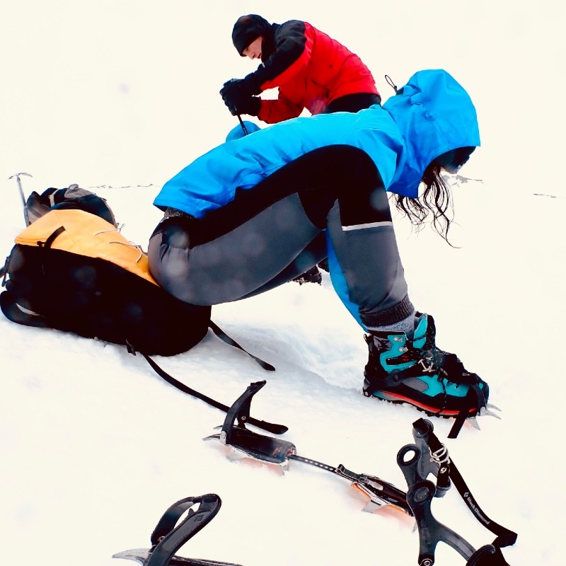 winter skills and mountaineering fitting crampons in Glen Coe Scotland 2