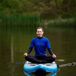 SUP yoga on a paddle board mindfulness and peace with ocean vertical in east lothian
