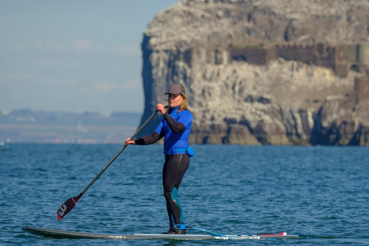 SUP paddle boarding at seacliff beach in east lothian with ocean vertical 1