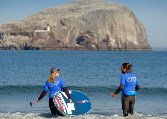 Mollie Hughes is SUP paddle boarding with Starboard and the Bass Rock in the background East Lothian Scotland