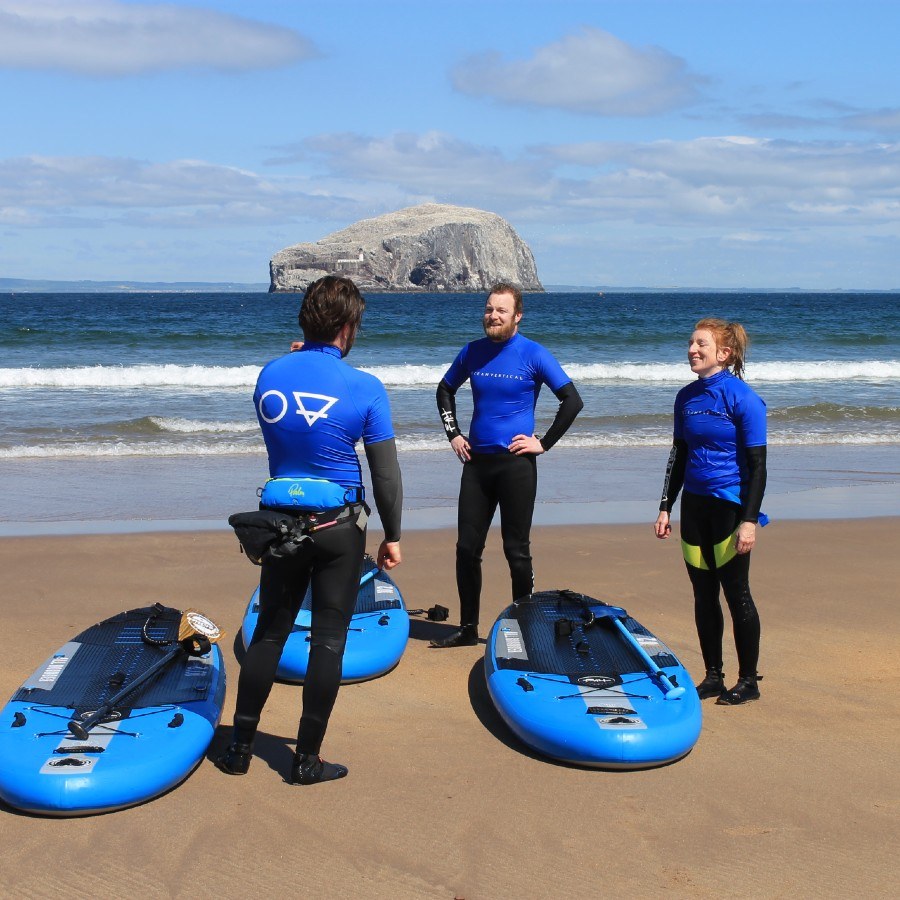SUP paddle boarding with the Bass Rock in the background at Seacliff Beach in East Lothian