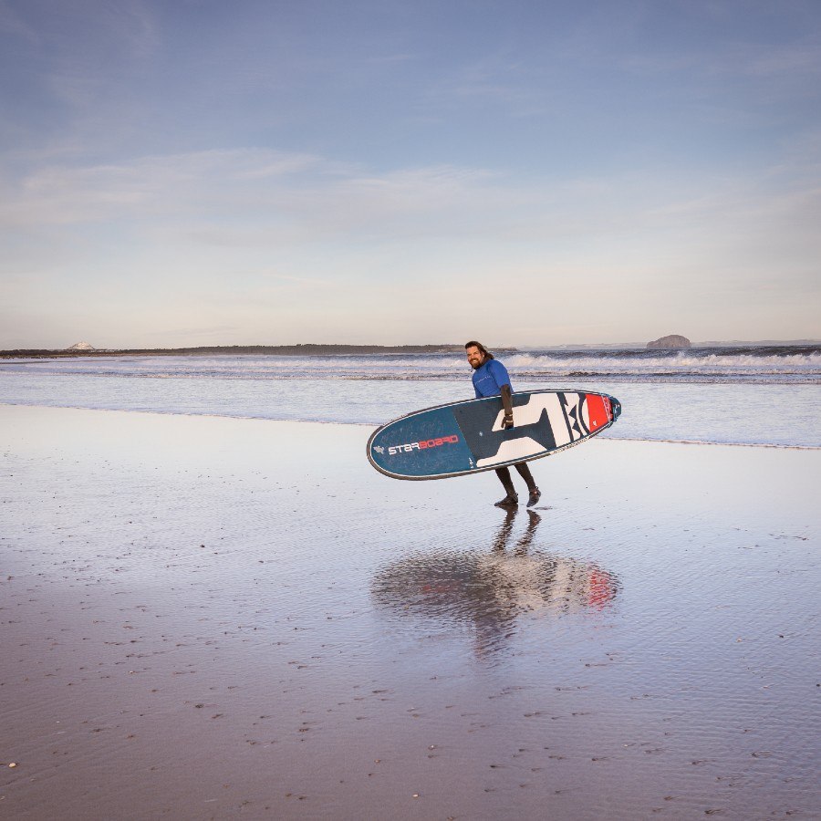 Starboard SUP paddle boarding on Belhaven Bay by Dunbar in East Lothian Scotland