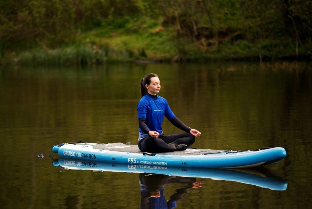 sup paddle board yoga with ocean vertical on a peaceful scottish loch meditation and mindfulness surrounded by nature