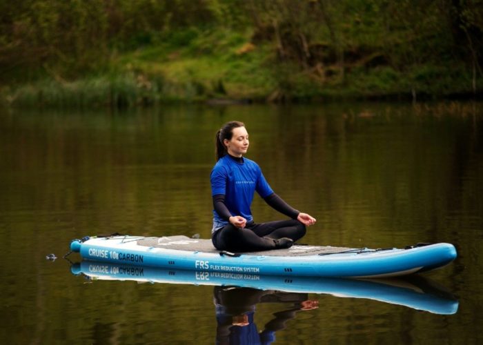 sup paddle board yoga with ocean vertical on a peaceful scottish loch meditation and mindfulness surrounded by nature