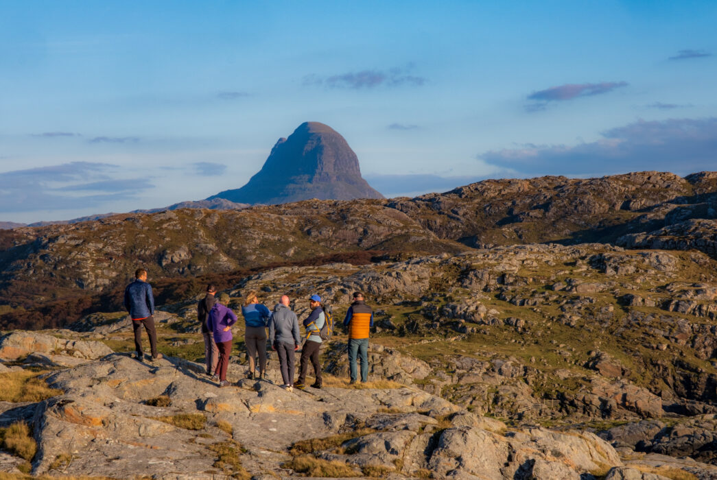 Suilven mountain viewed during a leadership course in the Scottish Highlands, with participants hiking and learning outdoor